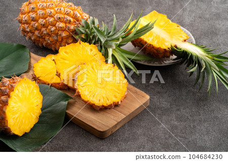 pineapple tropical leaves background sliced pineapple background パイナップル pineapple tropical leaves background sliced pineapple background パイナップル 104684230
