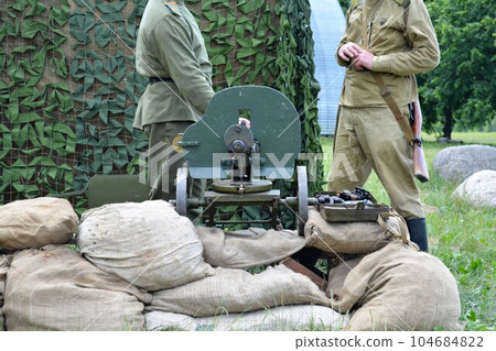 Russian soldiers of the imperial army at the machine gun "Maxim" during the First World War. Reconstruction. 104684822