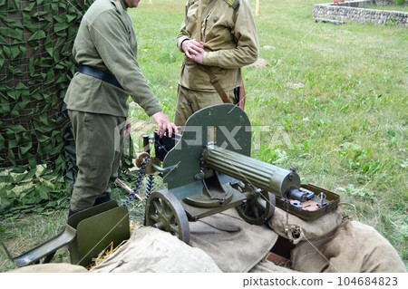 Russian soldiers of the imperial army at the machine gun "Maxim" during the First World War. Reconstruction. Russian soldiers of the imperial army at the machine gun "Maxim" during the First World War. Reconstruction. 104684823