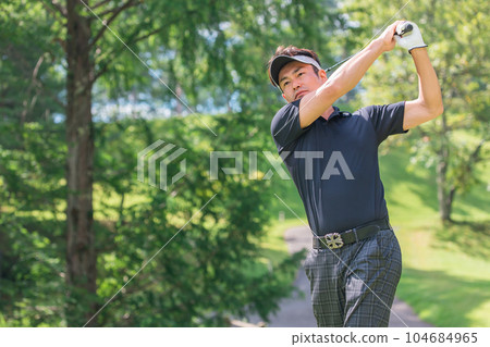 Golfer man hitting tee shot on golf course Golfer man hitting tee shot on golf course 104684965