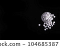 White Pills On Black Surface 104685387