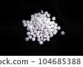 White Pills On Black Surface 104685388