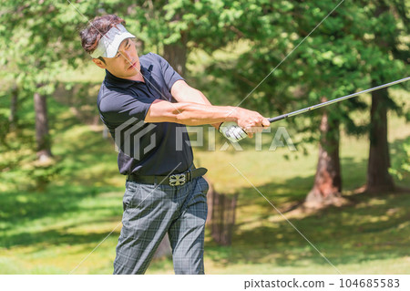 Golfer man playing golf on the golf course 104685583