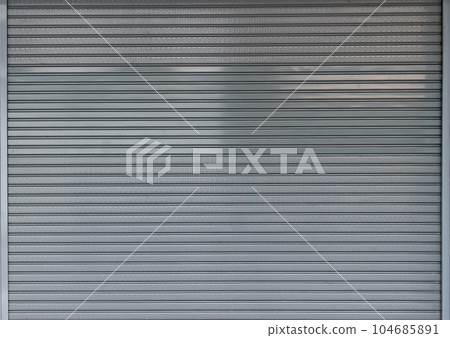 steel shutter door background and texture, folding steel door of shop. steel shutter door background and texture, folding steel door of shop. 104685891