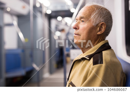 Old man sitting in subway car 104686087