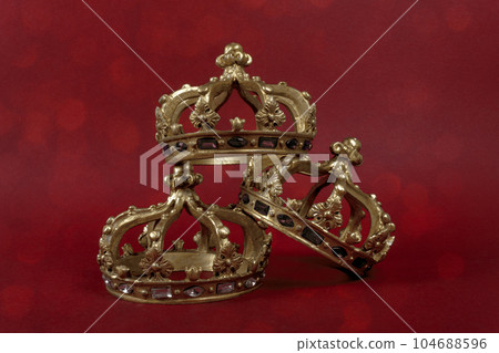 Three gold crowns on red background. Concept for Reyes Magos, Three Wise Men or Happy Epiphany day. 104688596