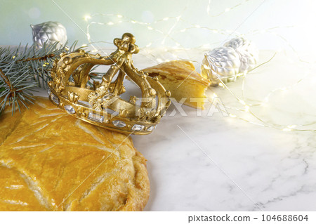 Three kings cake or galette des rois in French. Traditional epiphany cake with decorative crown. Three kings cake or galette des rois in French. Traditional epiphany cake with decorative crown. 104688604