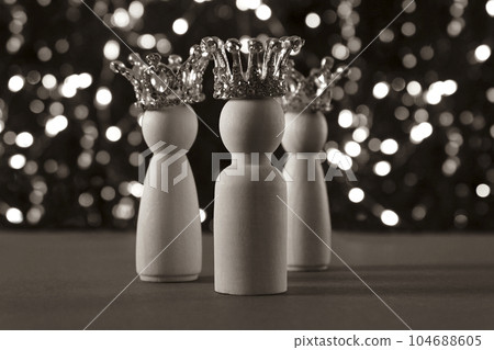 Three wise men figures with crowns on sepia glitter lights background. 104688605