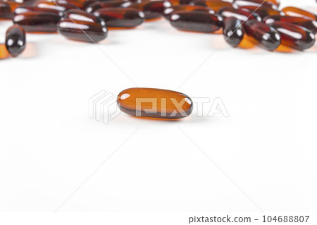 Leptin capsules on white background. Leptin is an appetite reducing hormone. Concept of losing weight, diet, fat burning, healthy eating. 104688807