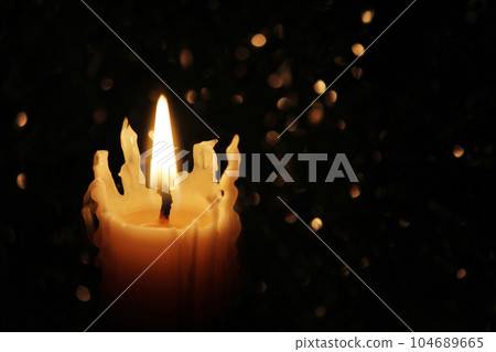 Candles Burning at Night. White Candles Burning in the Dark with focus on single candle in foreground. 104689665