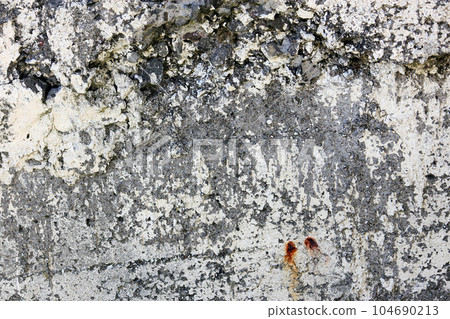 Old dark gray grungy concrete wall, background photo texture.  104690213