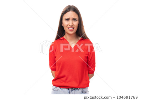 young brunette lady in a red t-shirt looks confusedly at the camera on a white background with copy young brunette lady in a red t-shirt looks confusedly at the camera on a white background with copy 104691769
