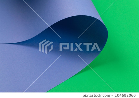 Abstract design of green curve shaped paper on orange background. Abstract design of green curve shaped paper on orange background. 104692066
