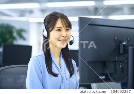 Smiling young female operator working in the office 104692227