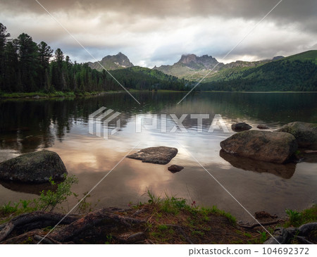 Rain at sunset at a mountain lake. Ergaki Nature Park in the mountains of Siberia. Western Sayan. 104692372