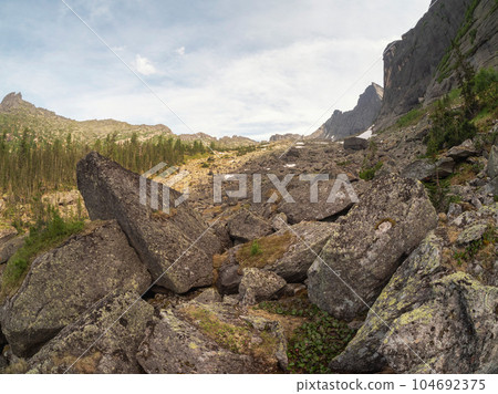 Mountain track through Western Sayans kurumnik, stones, cobblestones, moss with a unique landscape. Landscape photography of stone river (called also stone run, stone stream or stone sea. Mountain track through Western Sayans kurumnik, stones, cobblestones, moss with a unique landscape. Landscape photography of stone river (called also stone run, stone stream or stone sea. 104692375