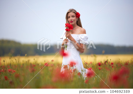 Girl in a flower field Girl in a flower field 104692389