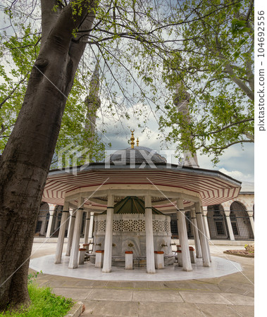 Courtyard of Atik Valide Ottoman Mosque, with ablution fountain in the front, located in Uskudar, Istanbul, Turkey 104692556