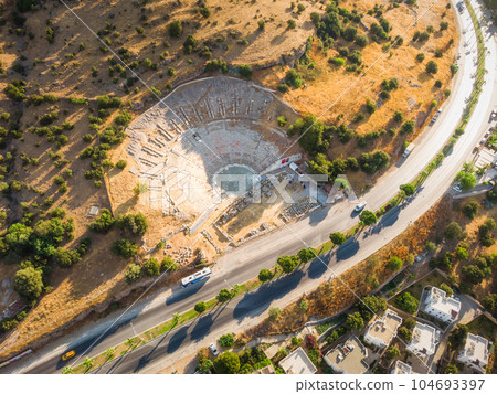 Aerial photo of historical places, theater ruins, massive ancient theatre of Halicarnassus, Bodrum, Turkey with highway crossing town.  104693397