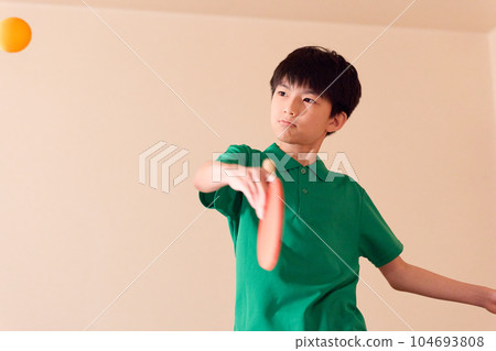 Elementary school boy playing table tennis Elementary school boy playing table tennis 104693808