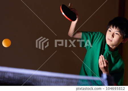 Elementary school boy playing table tennis 104693812