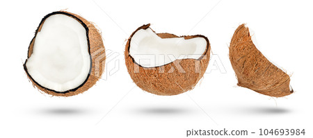 Flying coconut. Halves of coconuts on a white isolated background. Parts of coconuts with a crust cast a shadow close-up. 104693984