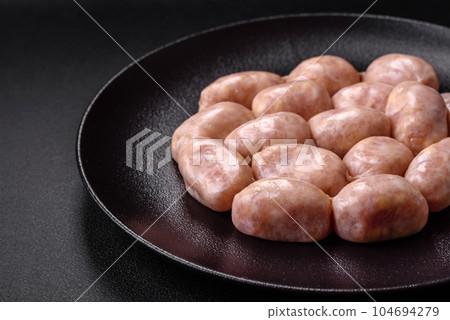 Fresh raw sausages from pork or chicken with salt, spices and herbs 104694279