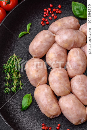 Fresh raw sausages from pork or chicken with salt, spices and herbs 104694299