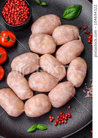 Fresh raw sausages from pork or chicken with salt, spices and herbs Fresh raw sausages from pork or chicken with salt, spices and herbs 104694322
