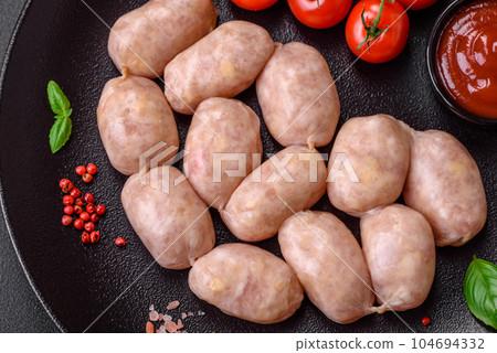 Fresh raw sausages from pork or chicken with salt, spices and herbs Fresh raw sausages from pork or chicken with salt, spices and herbs 104694332