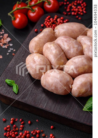 Fresh raw sausages from pork or chicken with salt, spices and herbs 104694338