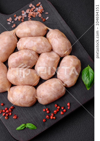 Fresh raw sausages from pork or chicken with salt, spices and herbs 104694351
