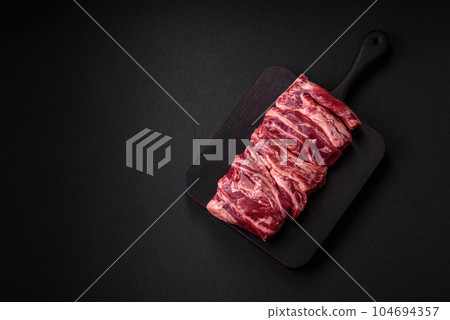 Fresh raw beef ribs with salt, spices and herbs Fresh raw beef ribs with salt, spices and herbs 104694357