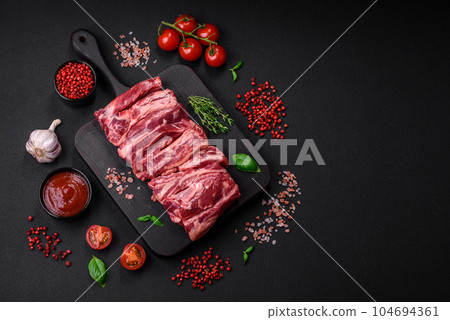 Fresh raw beef ribs with salt, spices and herbs 104694361
