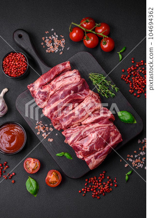 Fresh raw beef ribs with salt, spices and herbs 104694362