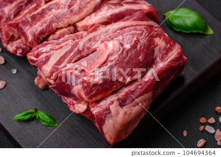 Fresh raw beef ribs with salt, spices and herbs 104694364