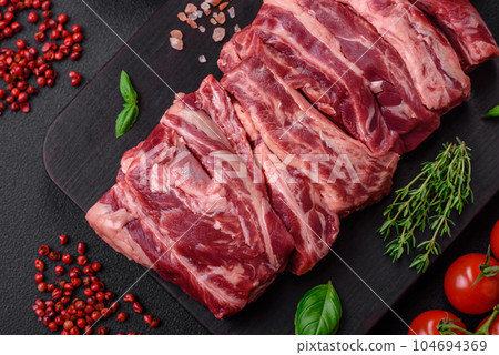 Fresh raw beef ribs with salt, spices and herbs Fresh raw beef ribs with salt, spices and herbs 104694369