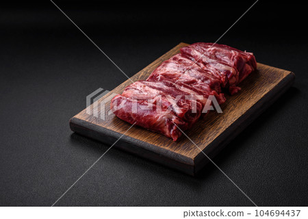 Fresh raw beef ribs with salt, spices and herbs Fresh raw beef ribs with salt, spices and herbs 104694437