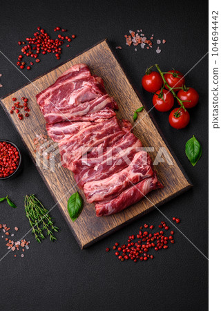 Fresh raw beef ribs with salt, spices and herbs Fresh raw beef ribs with salt, spices and herbs 104694442