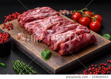 Fresh raw beef ribs with salt, spices and herbs Fresh raw beef ribs with salt, spices and herbs 104694443