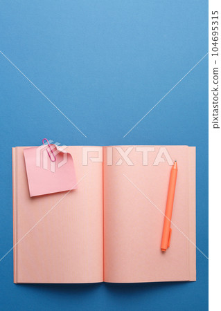Open notepad with pen, plant and note sheet. Open notepad with pen, plant and note sheet. 104695315