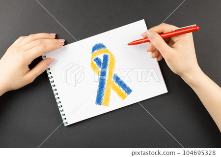 hands draw yellow blue ukraine ribbon 104695328