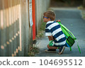 Little child from primary school happily reading, Kid boy wearing eye glasses. school, education concept. Pupil with backpack goes to school 104695512