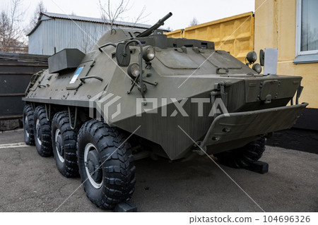 Green infantry fighting vehicle at a military base. 104696326