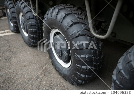 Big black wheels of an all-terrain vehicle. Big black wheels of an all-terrain vehicle. 104696328