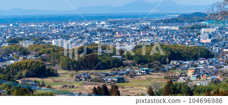 Panoramic cityscape of Omuta City against the blue sky "The island in the back is the Shimabara Peninsula, the sea is the Ariake Sea, and the cityscape is Omuta City." Panoramic cityscape of Omuta City against the blue sky "The island in the back is the Shimabara Peninsula, the sea is the Ariake Sea, and the cityscape is Omuta City." 104696986