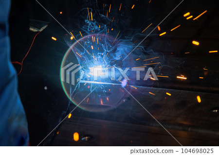 Using semi-automatic argon arc welding skilled welder executes precise during welding works. 104698025