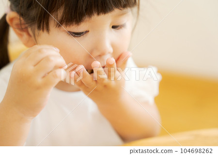 photo of girl eating snacks 104698262