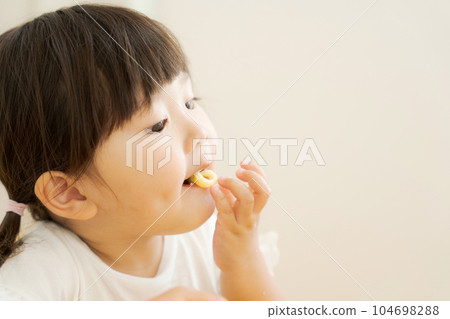 photo of girl eating snacks 104698288