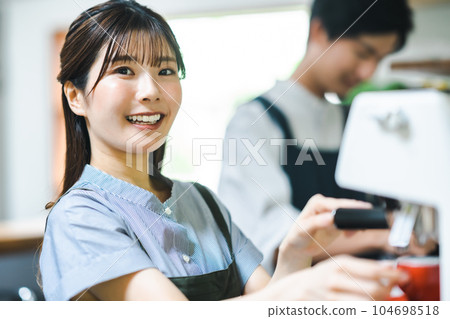 Young woman making espresso during barista training 104698518